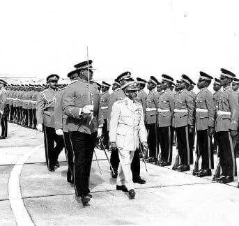 His Imperial Majesty Emperor Haile Selassie inspects a guard of honour of the 1st Batallion, Jamaica Regiment at the Montego Bay airportshortly before his departure. Escorting him is Major Leslie Lloyd.