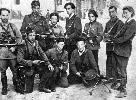 Abba Kovner (standing, center) with members of the FPO in the Vilna Ghetto. Rozka Korczak is to his left, and Vitka Kempner is at far right.